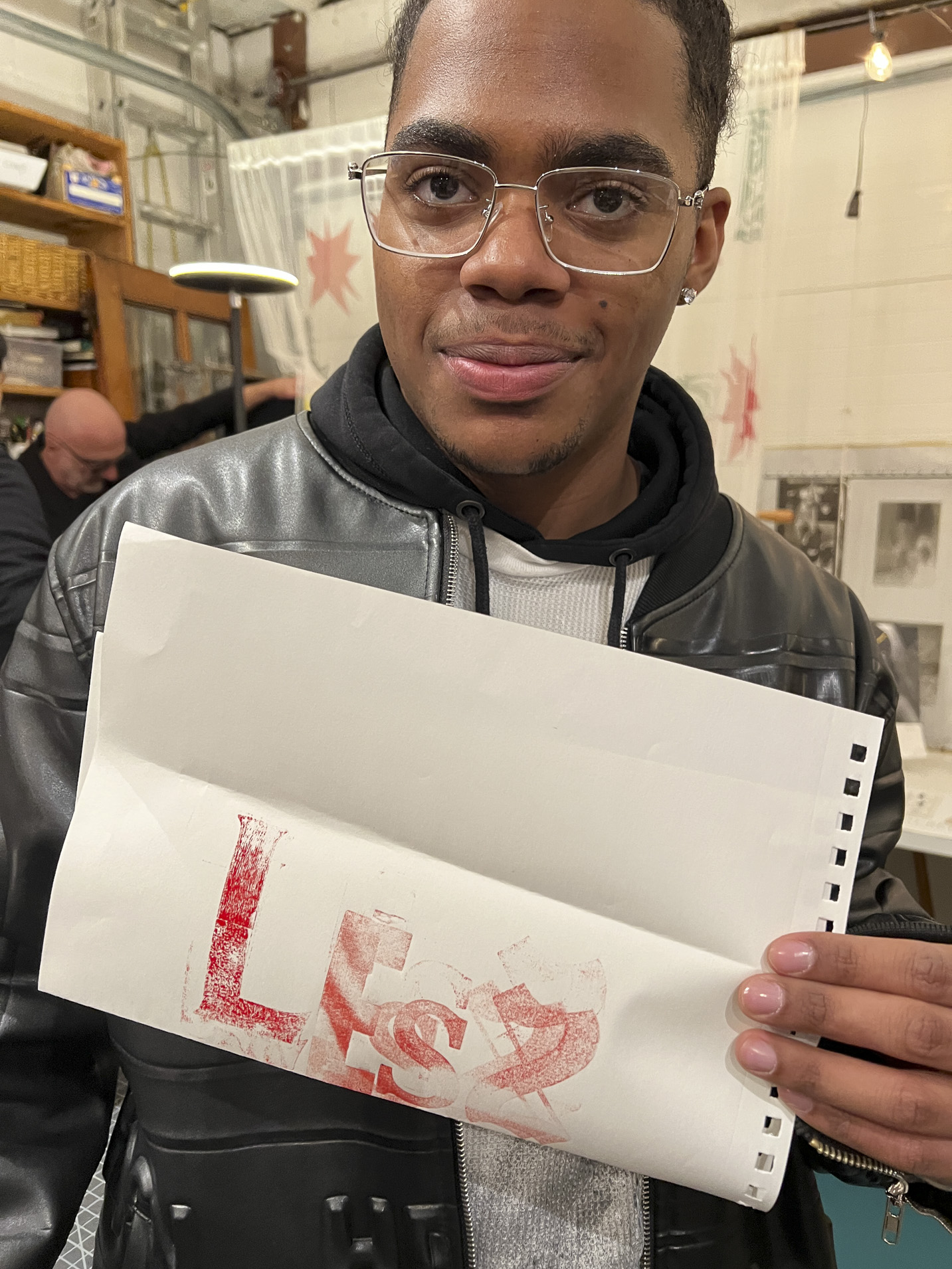 Tisch student holding a print made with hand-set type